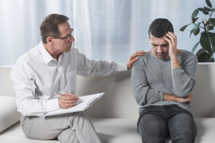 Counsellor helping a client manage stress, anxiety, and depression during a therapy session